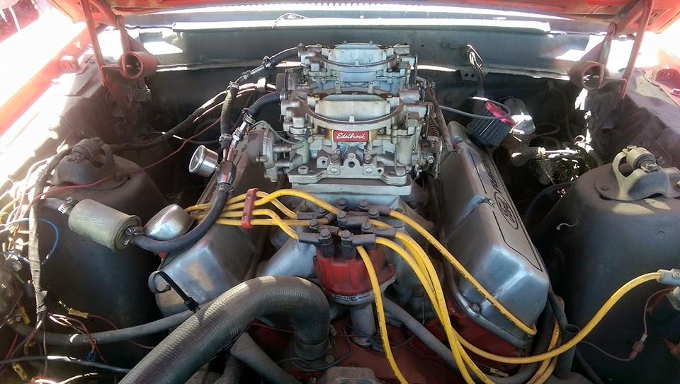 Carbureted V8 engine bay with an Edelbrock intake and yellow plug leads