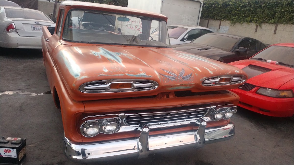Orange 1960 Chevrolet C10 pickup in the yard